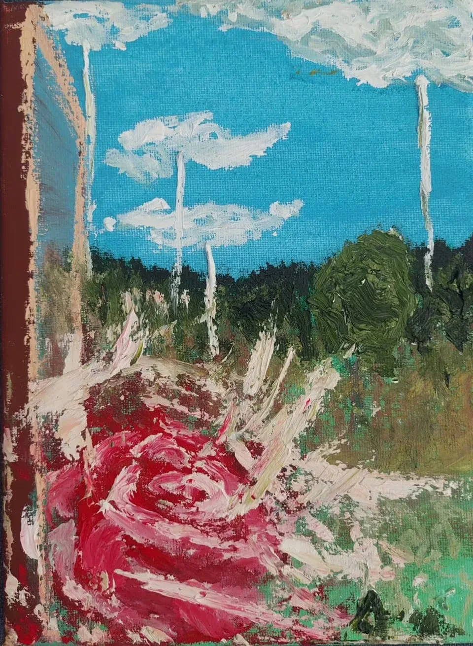 A red rose rises from dark green foliage beneath a turquoise sky streaked with white cloud.